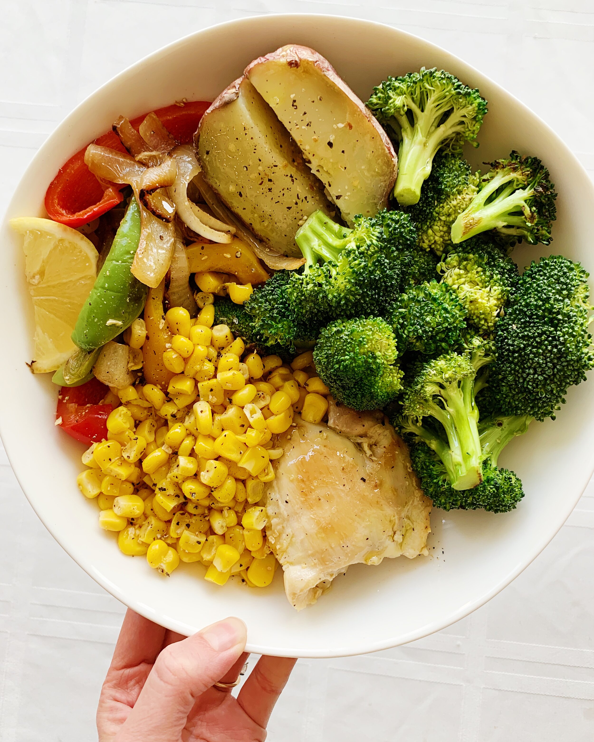 Chicken Thighs with broccoli, stir-fried peppers and onions, corn, and half a potato 